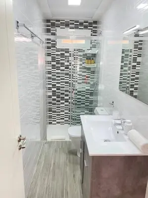 a bathroom with a sink and a toilet and a shower at Seahorse apartment El Perelló in El Perelló