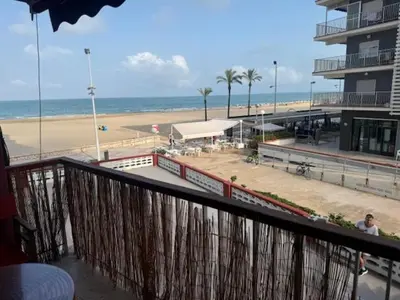 a balcony with a view of a beach and the ocean at Apartamento Arenal 1a Linea de Playa in Cullera