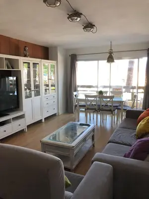 a living room with a couch and a coffee table at Apartamento en complejo residencial con piscina in Puebla de Farnals