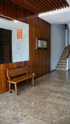 a wooden bench in a room with a staircase at Apartamento en complejo residencial con piscina in Puebla de Farnals