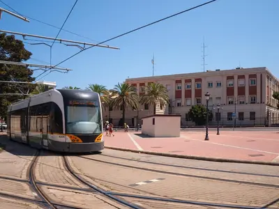 a tram on the tracks in a city at ApartUP Ca La Leni Beach I in Valencia