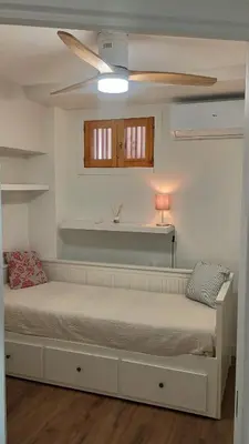 a bedroom with a bed and a ceiling fan at ROYAL BEACH - Appartment with sea view & terrace in Faro de Cullera