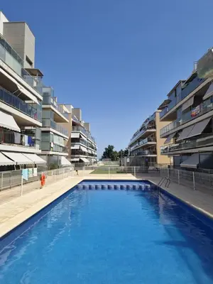 a swimming pool in front of some apartment buildings at Apartamento playa Moncofa-Chilches in Chilches