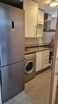 a kitchen with a refrigerator and a washing machine at Apartamento playa Moncofa-Chilches in Chilches