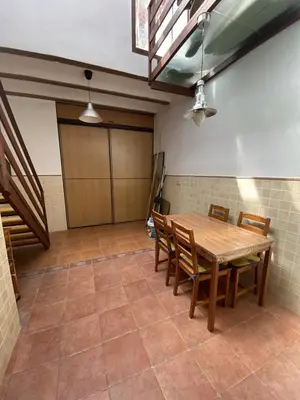 a dining room with a wooden table and chairs at Casa Rural El Molino in Macastre