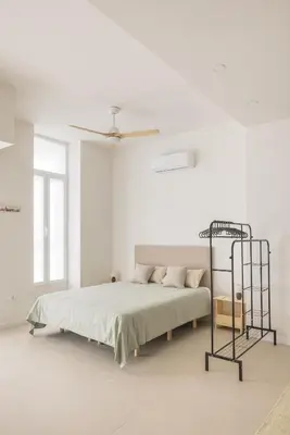 a white bedroom with a bed and a ceiling at Casa Ramona Ruzafa Valencia Centro in Valencia