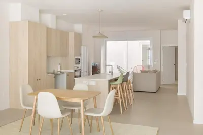 a kitchen and dining room with a table and chairs at Casa Ramona Ruzafa Valencia Centro in Valencia