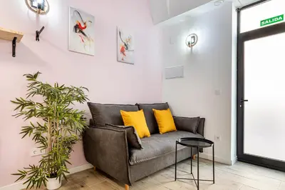 a living room with a gray couch and yellow pillows at Marie Curie Flats, Lovely Loft in Valencia