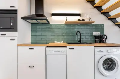 a kitchen with a sink and a washing machine at Marie Curie Flats, Lovely Duplex 2 in Valencia
