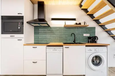 a kitchen with white cabinets and a washer and dryer at Marie Curie Flats, Lovely Duplex 3 in Valencia