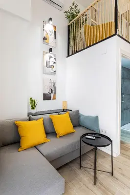 a living room with a gray couch with yellow pillows at Marie Curie Flats, Lovely Duplex 3 in Valencia