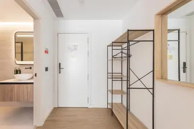 a bathroom with a spiral staircase next to a mirror at Guastavino by Alma Suites in Valencia