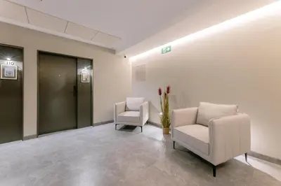 a waiting room with two chairs and a elevator at Guastavino by Alma Suites in Valencia