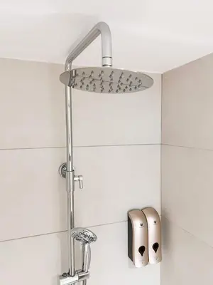 a shower head in a bathroom with a sink at Apartamento junto a Ruzafa cerca del centro in Valencia