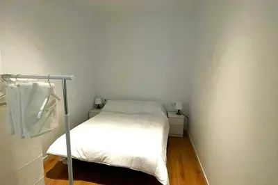 a small bedroom with a white bed in a room at Apartamento Cienciasmar in Valencia