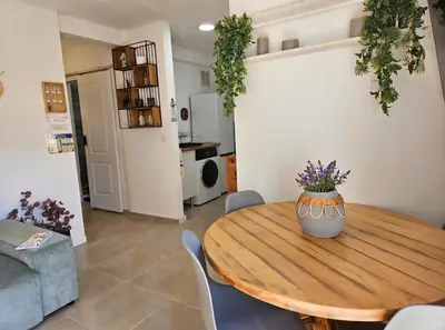 a dining room with a wooden table and chairs at Urban loft Valencia playa in Puebla de Farnals