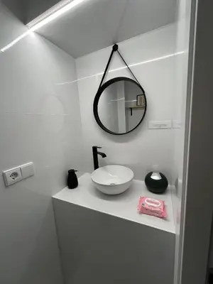 a white bathroom with a sink and a mirror at Casa La Culle in Favareta