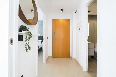 a hallway with a brown door and white walls at Apartamento Palermo Living Suites en Burriana in Burriana