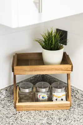 a wooden tray with four glass jars on a counter with a plant at Apartamento Palermo Living Suites en Burriana in Burriana