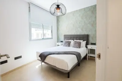 a bedroom with a large bed and a window at Apartamento Palermo Living Suites en Burriana in Burriana
