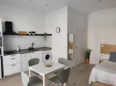 a kitchen with a table and chairs in a room at Loft nuevo cerca de Ruzafa in Valencia