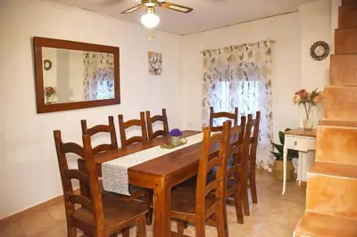 a dining room with a wooden table and chairs at Casa Rural Buñol Ca Maruja-Experiencia Unica in Buñol