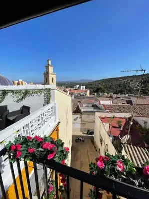 a view of a balcony with flowers on a building at Casa Rural Buñol Ca Maruja-Experiencia Unica in Buñol
