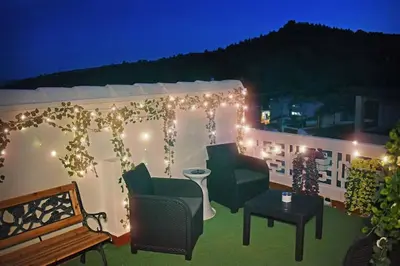 a patio with lights and chairs and a table at Casa Rural Buñol Ca Maruja-Experiencia Unica in Buñol