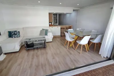 a living room with a couch and a table and chairs at Apartamento en Cullera in Cullera