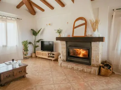 a living room with a fireplace and a television at Casa Marla, Siete Aguas in Siete Aguas