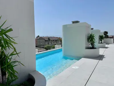 a swimming pool on the side of a building at Terrasses - Beach apartment with swimming pool in Puzol