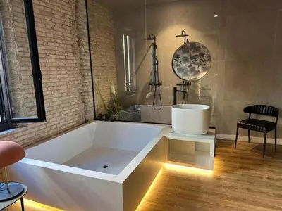 a large white bath tub in a room at Saman Hotel Boutique in Valencia