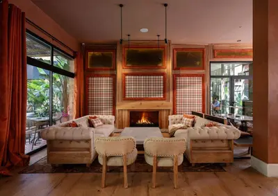 a living room with a fireplace and a table and chairs at Saman Hotel Boutique in Valencia