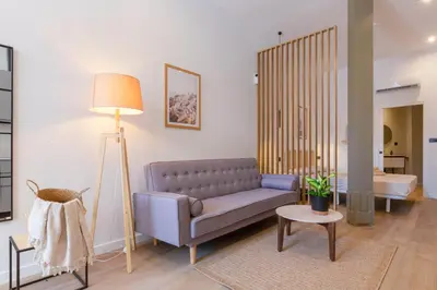 a living room with a couch and a table at Mestalla Flats by Nomad Host in Valencia