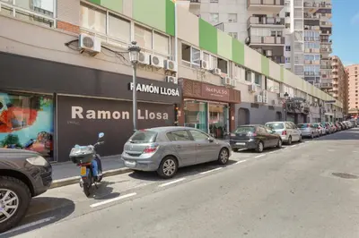 a row of cars parked on the side of a street at Mestalla Flats by Nomad Host in Valencia