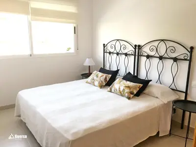 a bed with white sheets and pillows on it at SOL Y PLAYA -Playa Canet de Berenguer-La Almardá Valencia Costa SPAIN in Canet de Berenguer