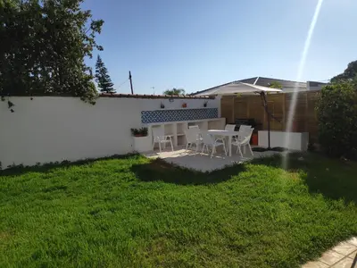 a patio with a table and chairs in a yard at La Casa del Sol in La Eliana