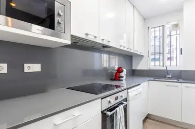 a kitchen with white cabinets and a stove top oven at Centrico, 2 habitaciones, confort ascensor,wifi AC in Valencia