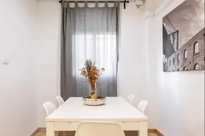 a white dining room table with white chairs and a plant on it at Centrico, 2 habitaciones, confort ascensor,wifi AC in Valencia
