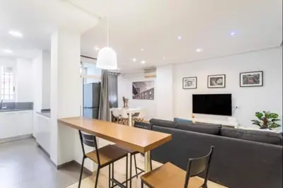 a living room with a couch and a table with chairs at Centrico, 2 habitaciones, confort ascensor,wifi AC in Valencia