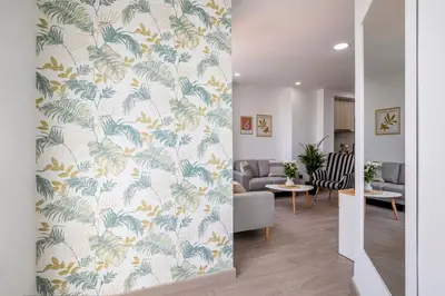 a living room with a wallpaper with palm trees at SingularStays Santa Clara II in Valencia