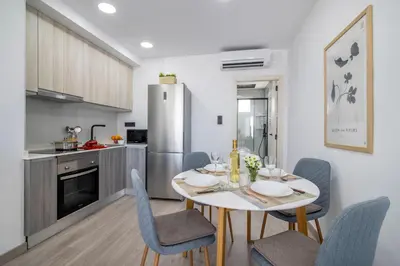 a kitchen and dining room with a table and chairs at SingularStays Santa Clara II in Valencia