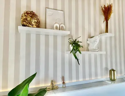 a bathroom with white shelves on a striped wall at Luxury penthouse center appartement in Valencia