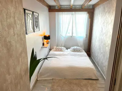 a small bedroom with a bed and a window at Luxury penthouse center appartement in Valencia