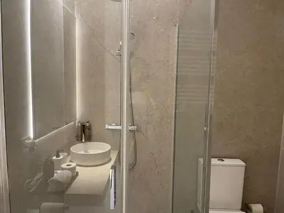 a bathroom with a shower and a sink and a toilet at Osito Hub - Campoamor in Valencia