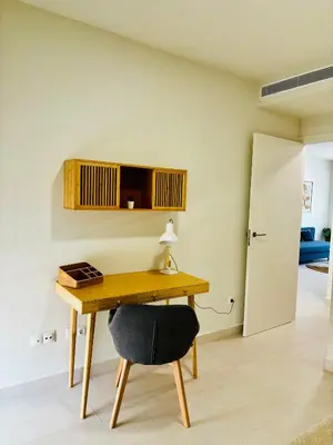 a desk with a lamp and a chair in a room at Travel Habitat Playa Puzol con encanto in Puzol