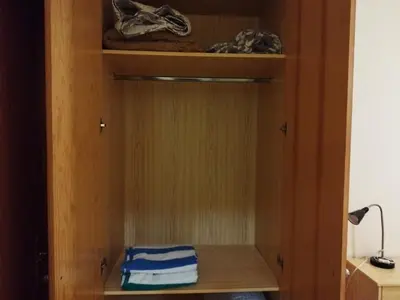 a wooden cabinet with two folded towels in it at Apartamento cerca del puerto deportivo 1 in Burriana