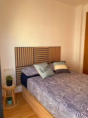a bed with two pillows on it in a bedroom at Cozy apartment near the beach in Puerto de Sagunto