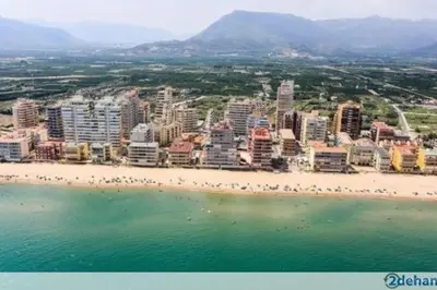 a view of a beach with buildings and a city at Appartement Tavernes de la Valldigna 4p in Valencia