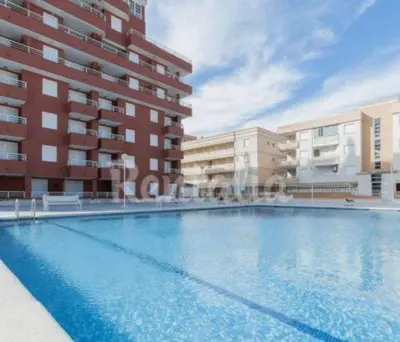 a large swimming pool in front of a building at Appartement Tavernes de la Valldigna 4p in Valencia